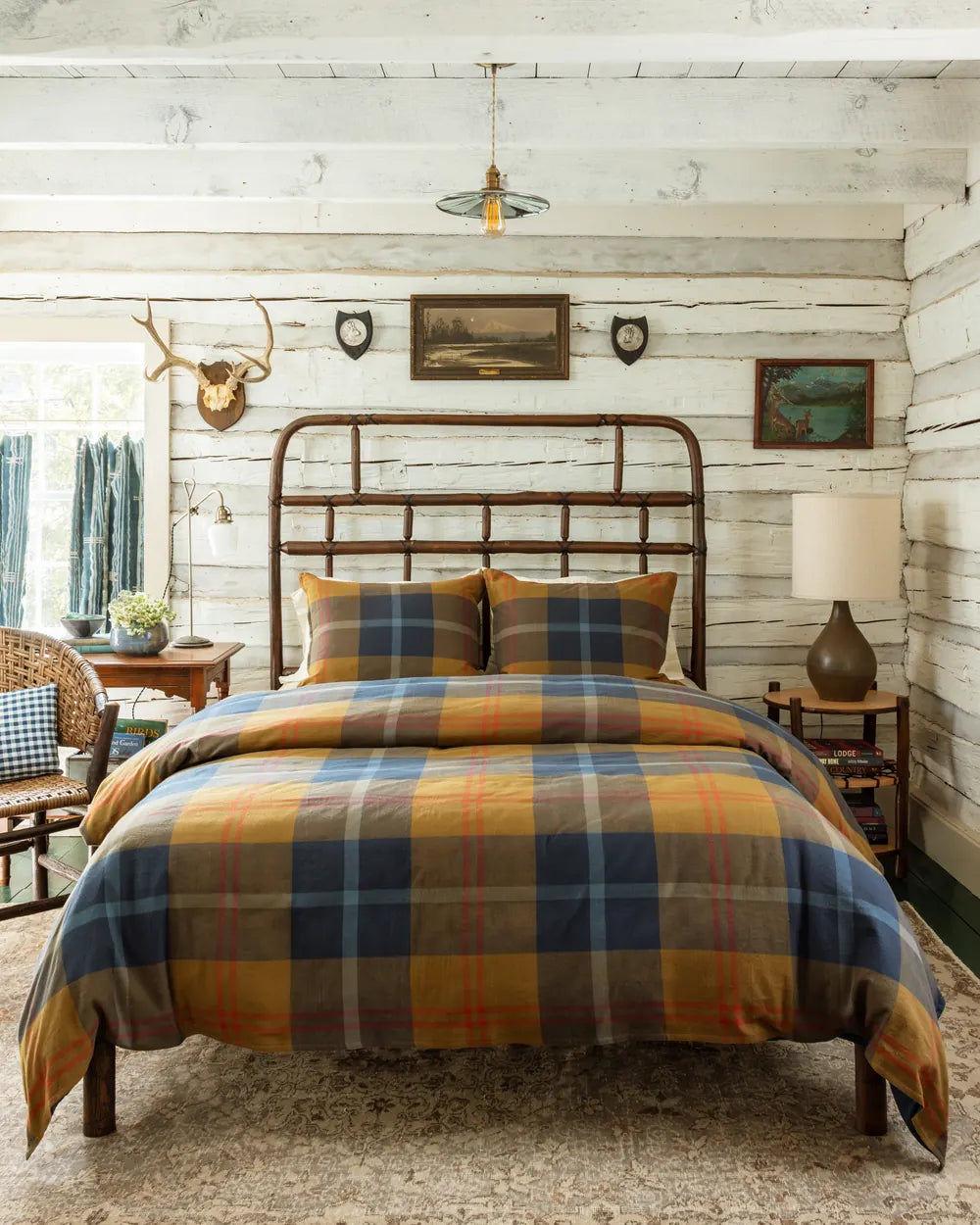 Pacific Plaid duvet cover and shams in gold, navy and rust on a hickory bed