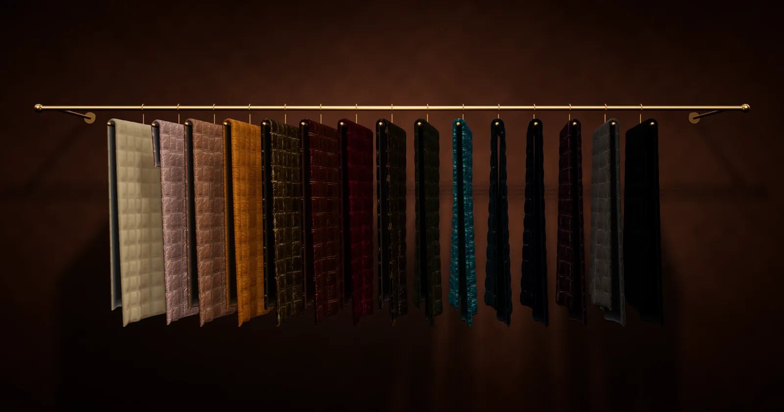 A brass rail hung with fifteen Stella velvet quilts, one in every shade